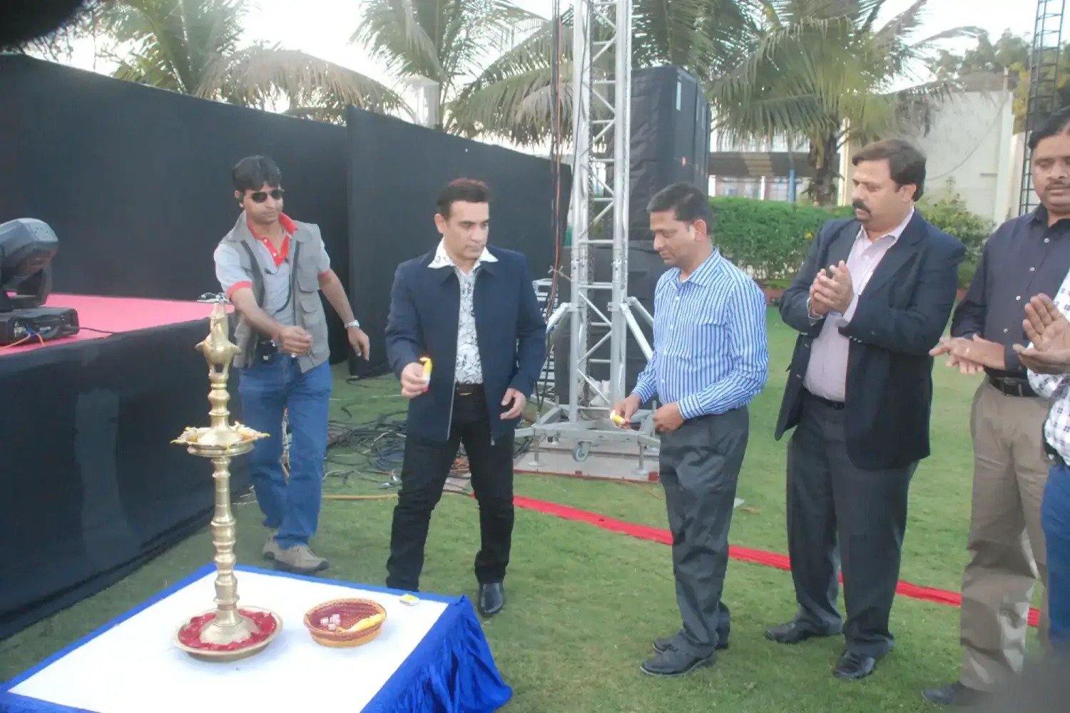 Group of men posing with large cartoon character inflatable figures at night outdoors